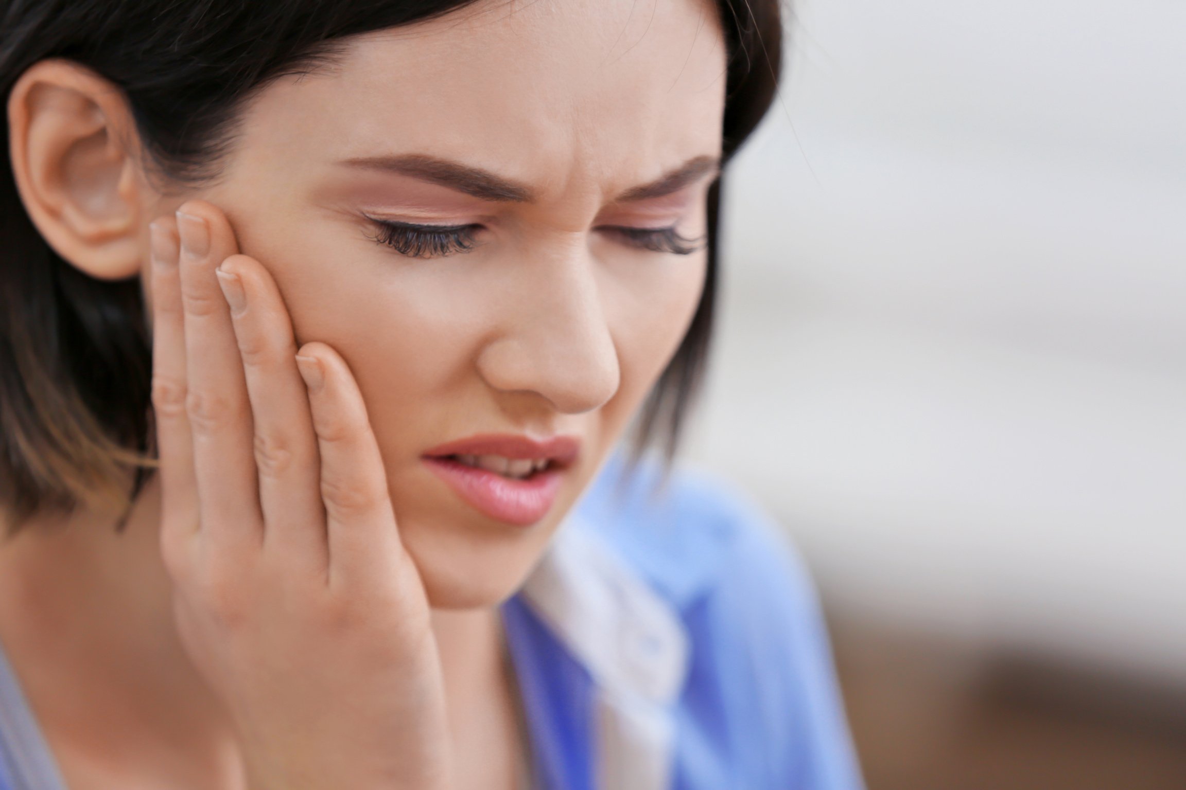 Young Woman Suffering from Toothache